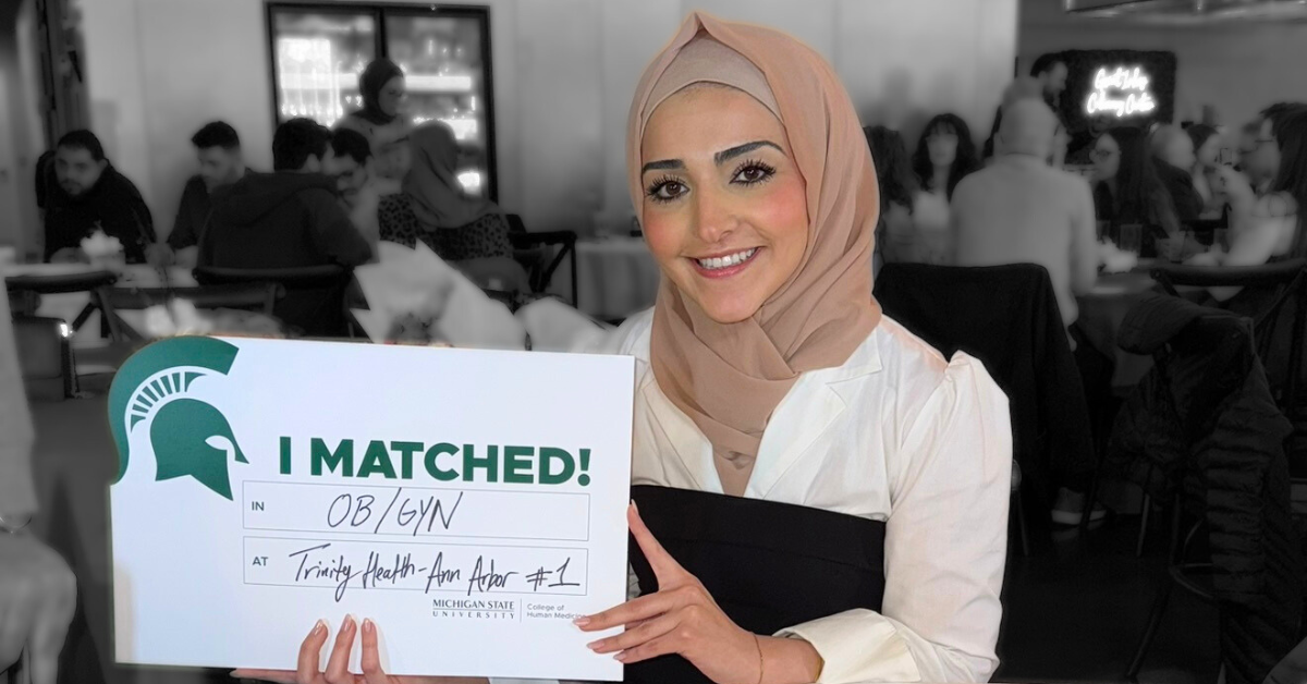 Rawan Hammoud holding her match day sign.